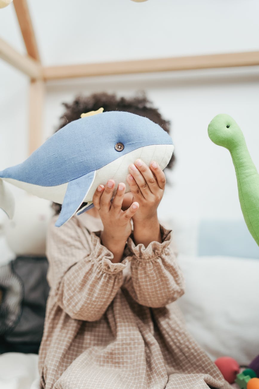 girl holding whale stuffed toy